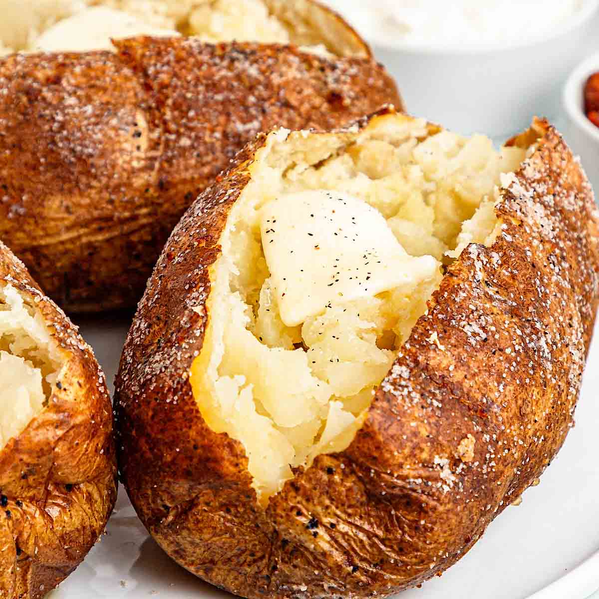 Baked potatoes topped with butter